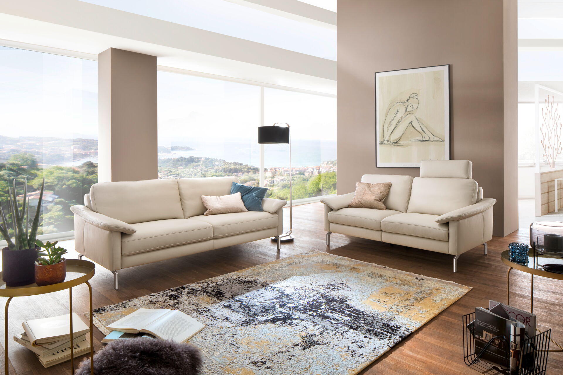 Möbel Lutz: Elegante Wohnzimmermöbel in Obernbreit Ein elegantes Wohnzimmer mit beigem Sofa und Zweisitzer, Teppich und großen Fenstern, eingerichtet mit Möbeln von Möbel Lutz aus Obernbreit.